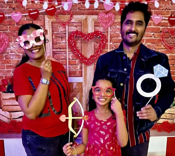 A Family takes a picture with hearts at a Valentine's Day Event at the Y