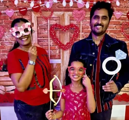 A Family takes a picture with hearts at a Valentine's Day Event at the Y