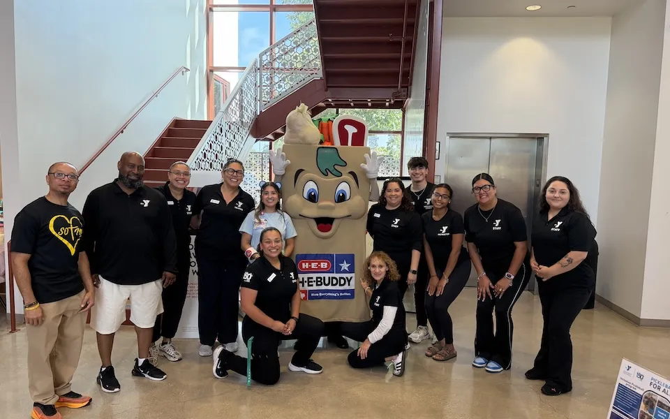 YMCA Staff posing with H-E-B Buddy Mascot