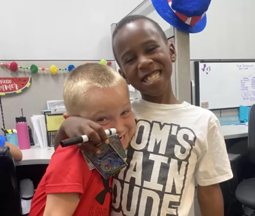 Two kids smiling at the Schertz Family YMCA
